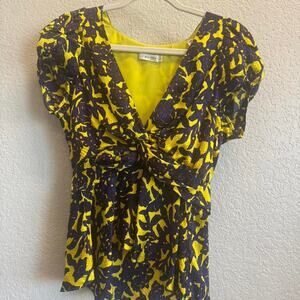 Yellow and purple floral blouse with a bow detail